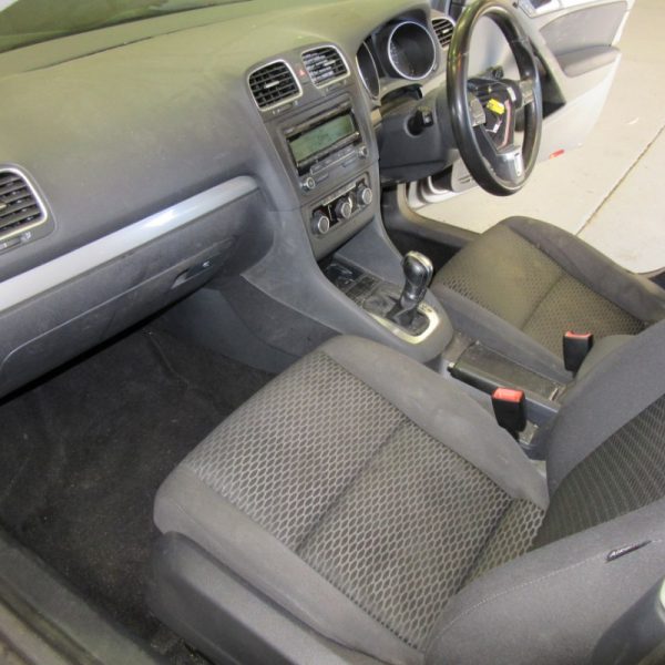 An old car's interior seats and dashboard