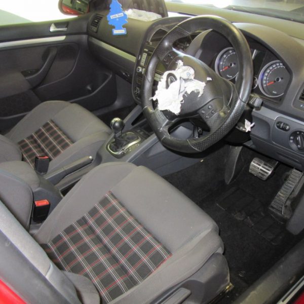 The interior seats and dashboard of a red Volkswagen Golf GTI MK5 2008 car