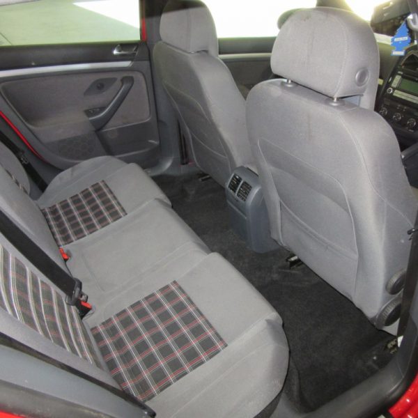 The interior seats of a red Volkswagen Golf GTI MK5 2008 car