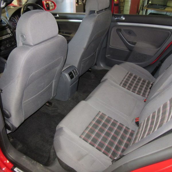 The interior seats of a red Volkswagen Golf GTI MK5 2008 car