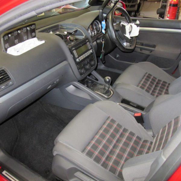The interior seats of a red Volkswagen Golf GTI MK5 2008 car