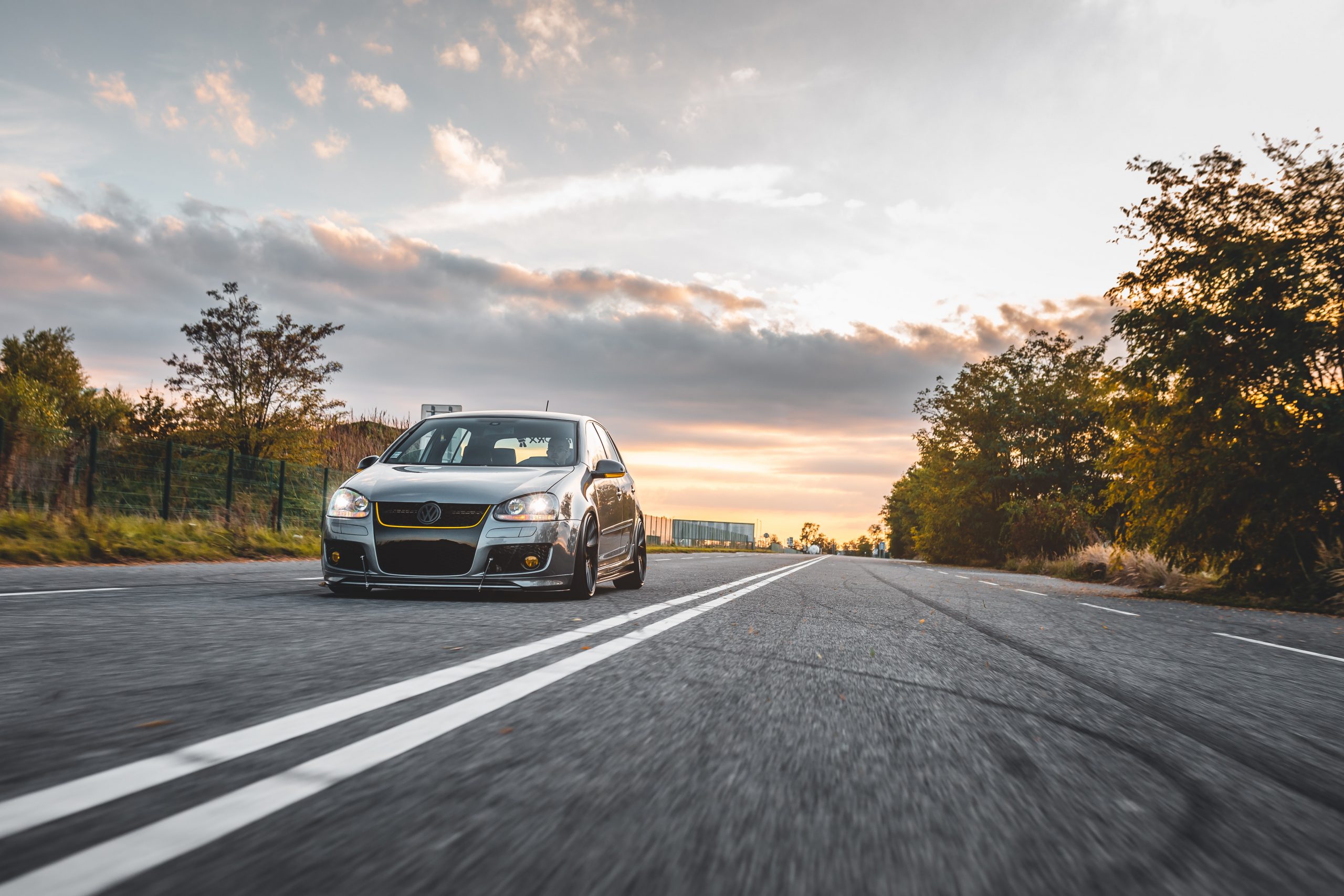 A performance volkswagen driving fast along the road