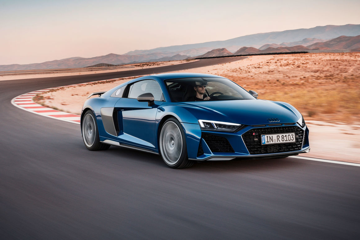 Audi R8 driving down road fast, blurred background