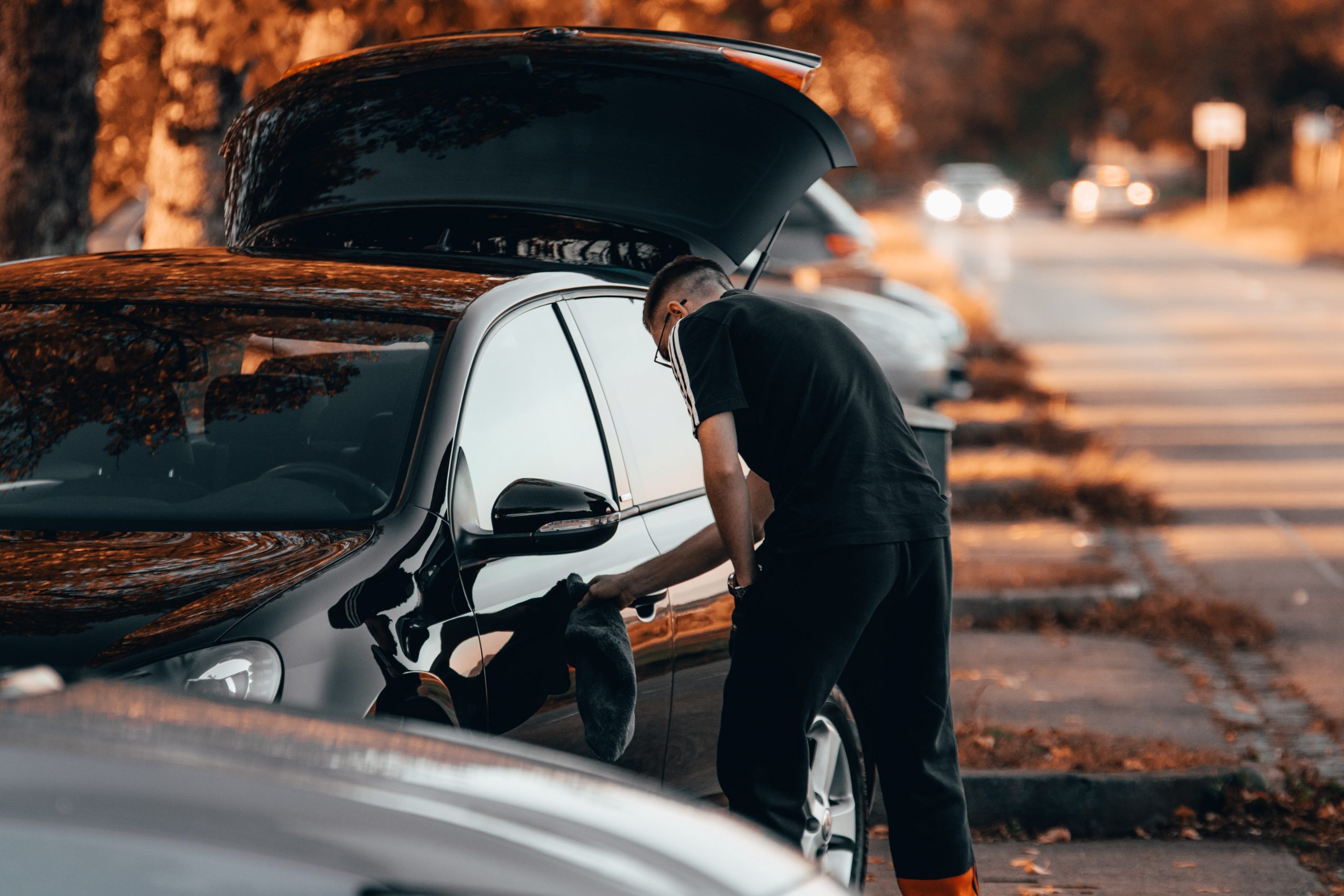 Man polishing his Volkswagen Golf
