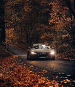 An Audi car drives along the road