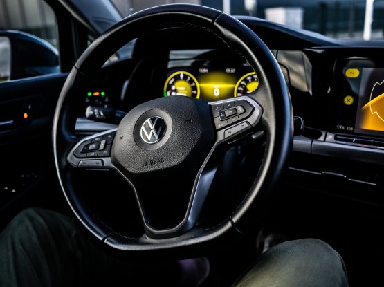 The interior view of a Volkswagen car, featuring the steering wheel and information display.