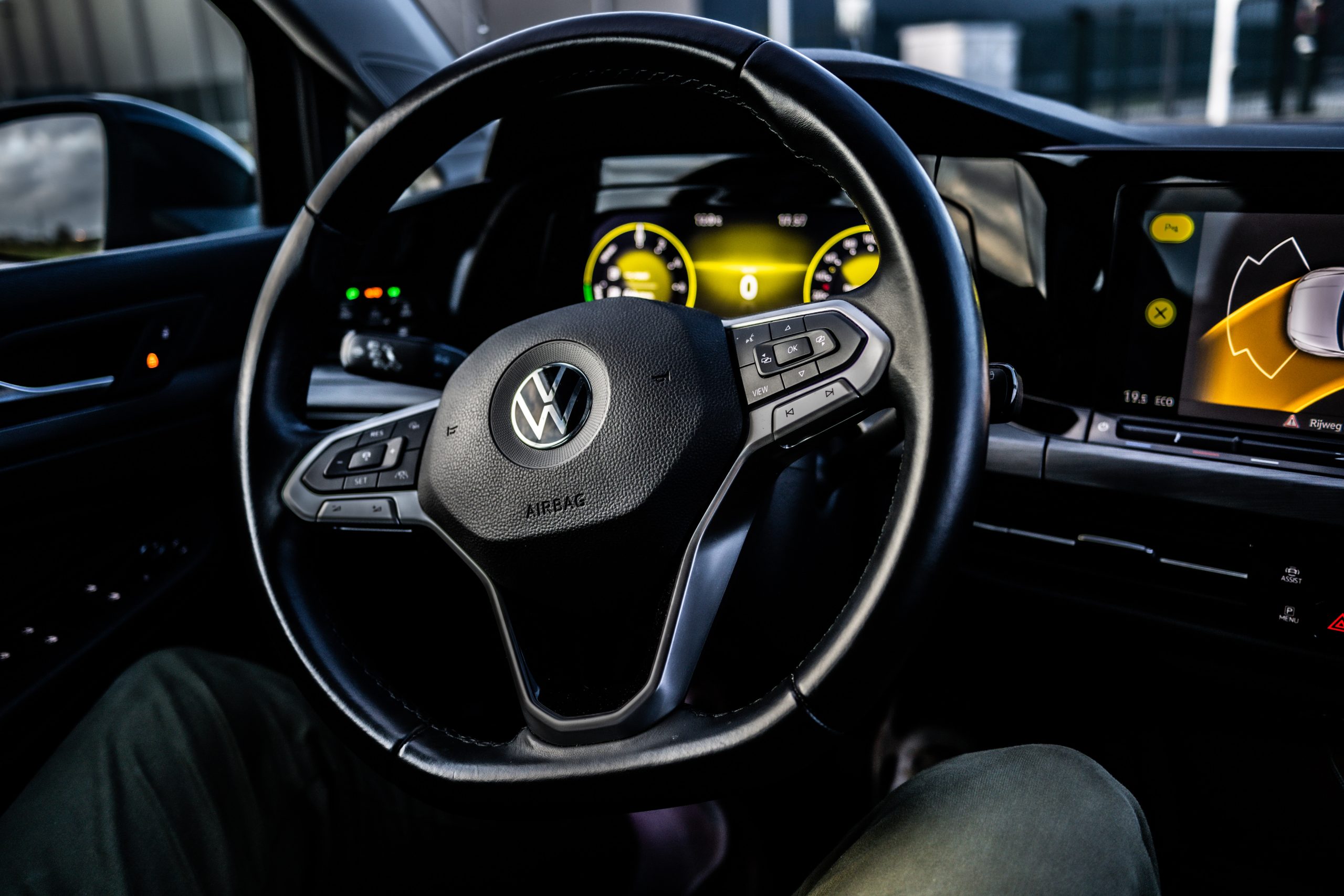 The interior view of a Volkswagen car, featuring the steering wheel and information display.